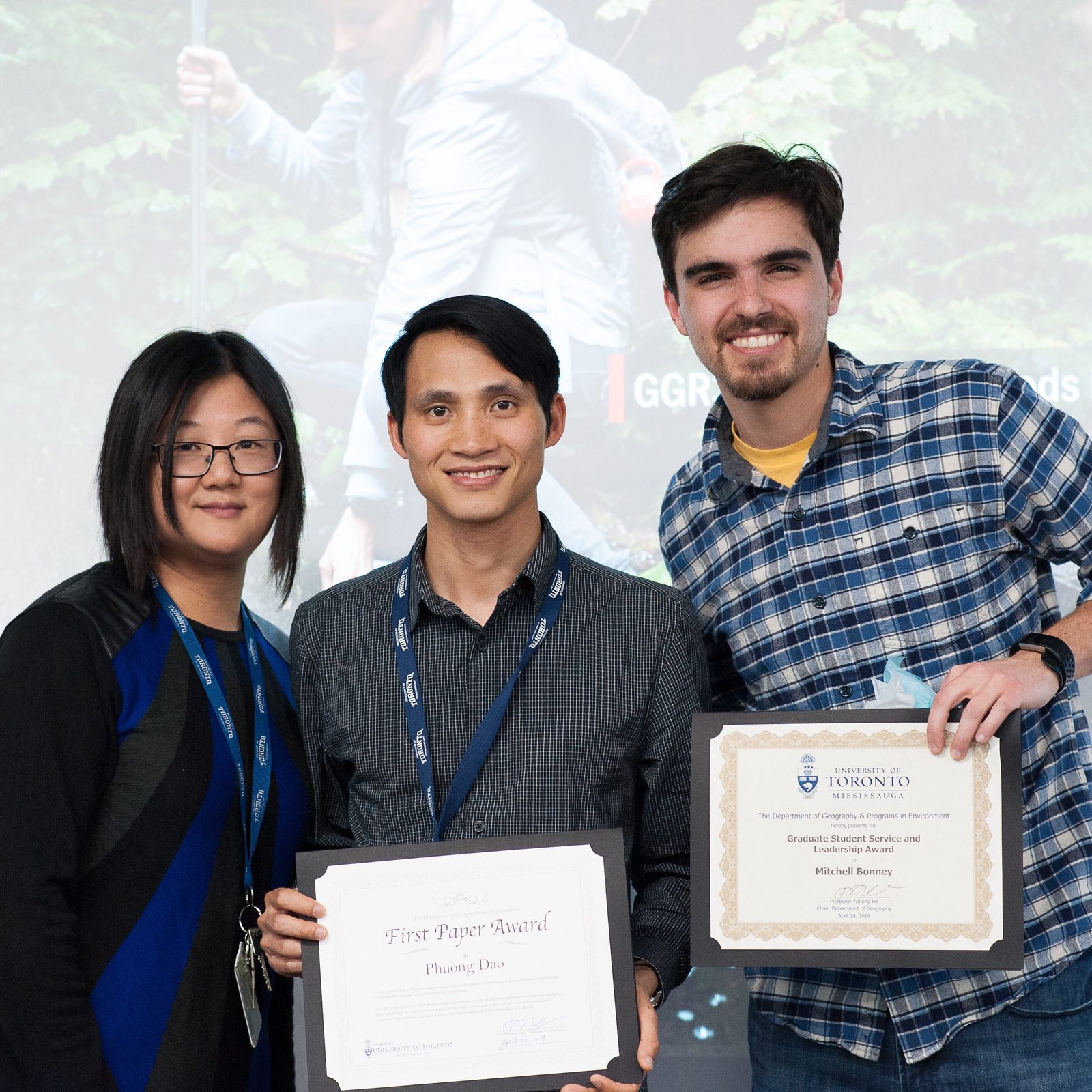 Prof. He with Phuong Dao and Mitchell Bonney holding their department awards