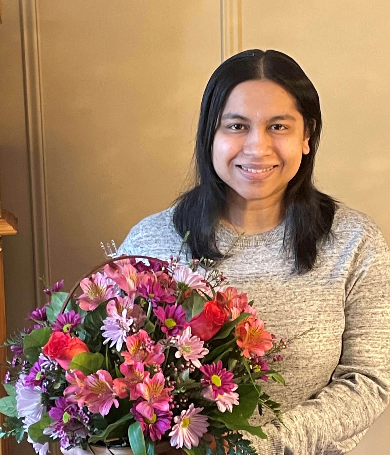 Dr. Leah Marajh with flowers after her defence